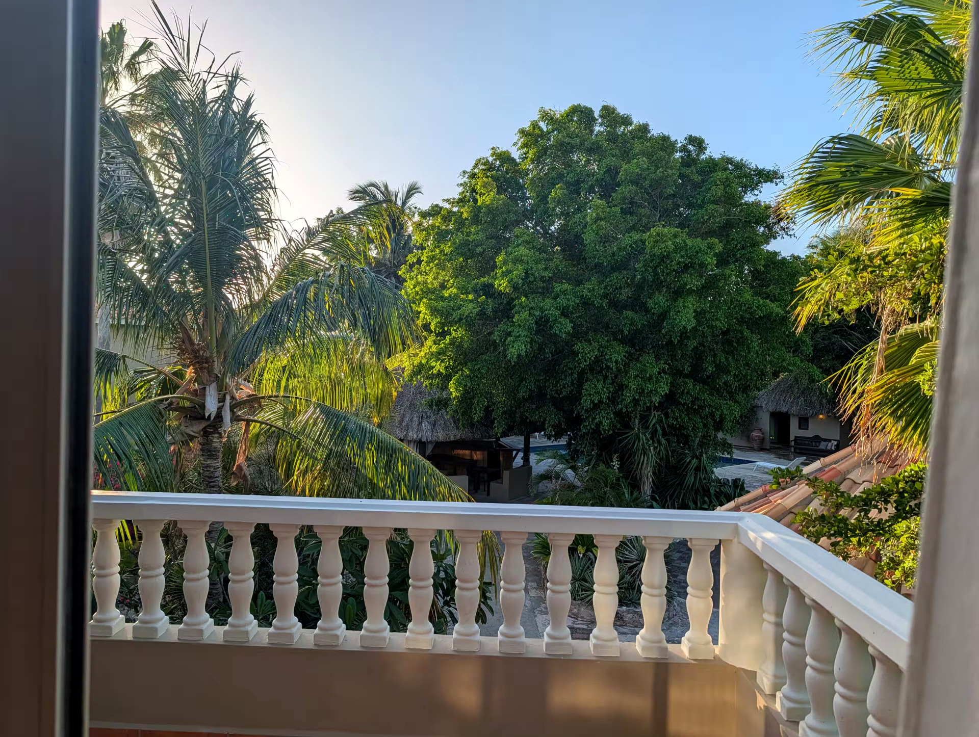 Private upstairs balcony overlooking palms and tropical gardens