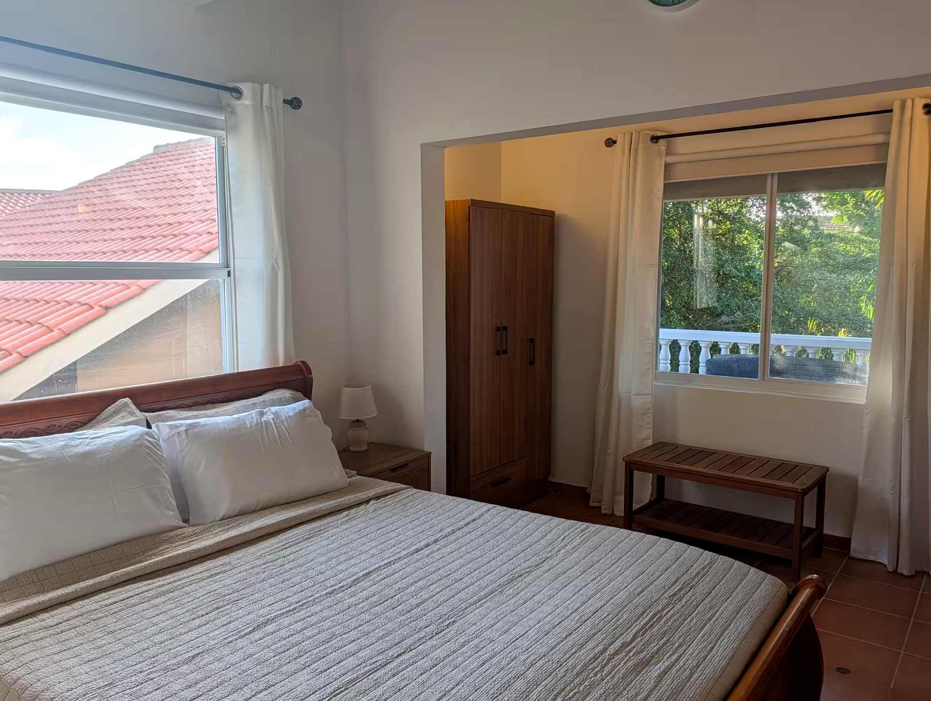 Bedroom with queen bed, storage and balcony access