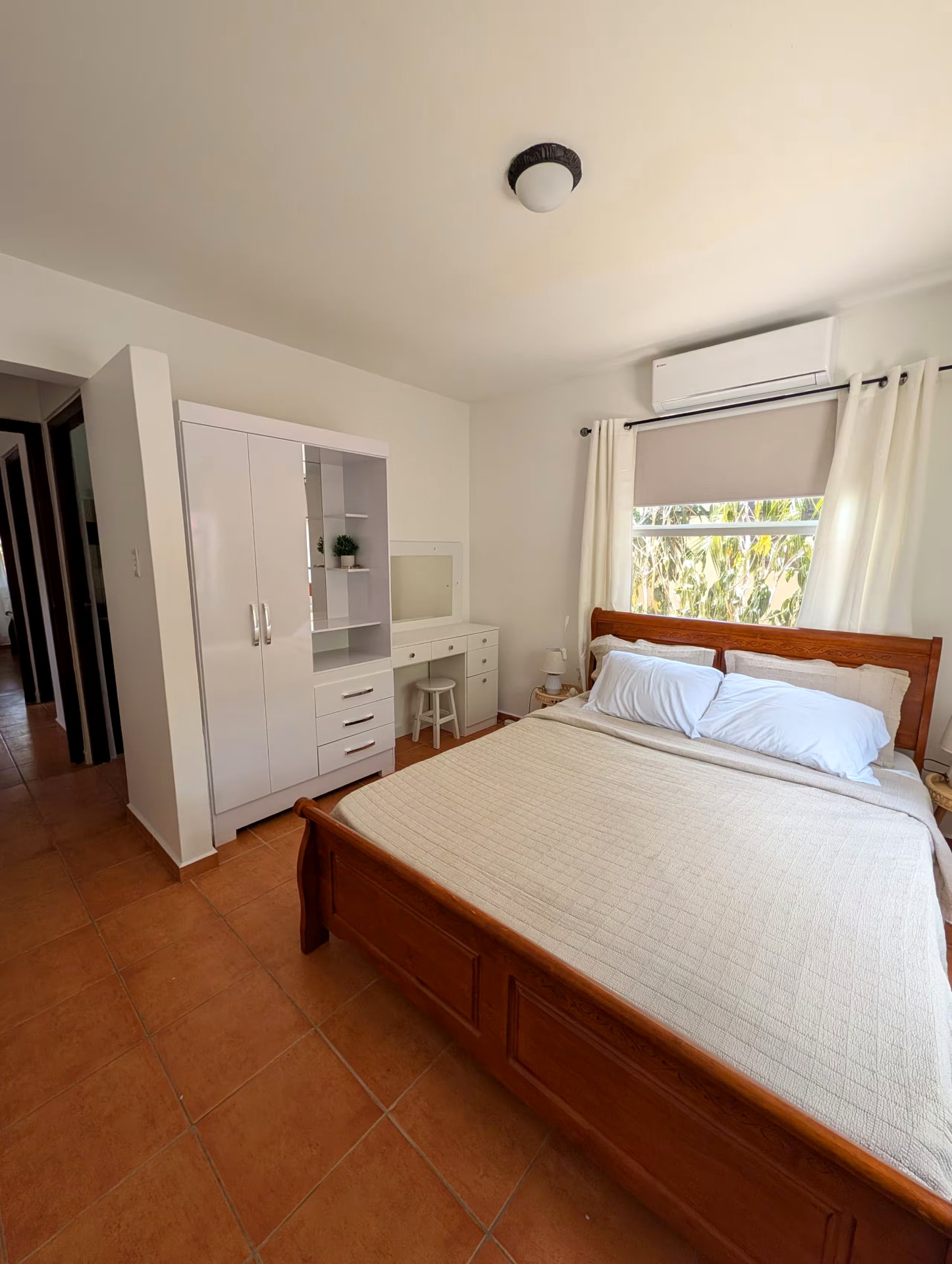 Bedroom with queen bed, wardrobe and air conditioning